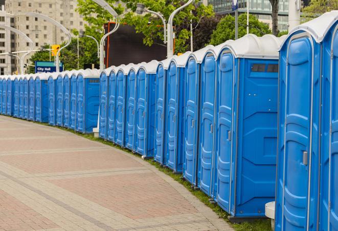 a line of portable restrooms at a sporting event, providing athletes and spectators with clean and accessible facilities in Ashland OR